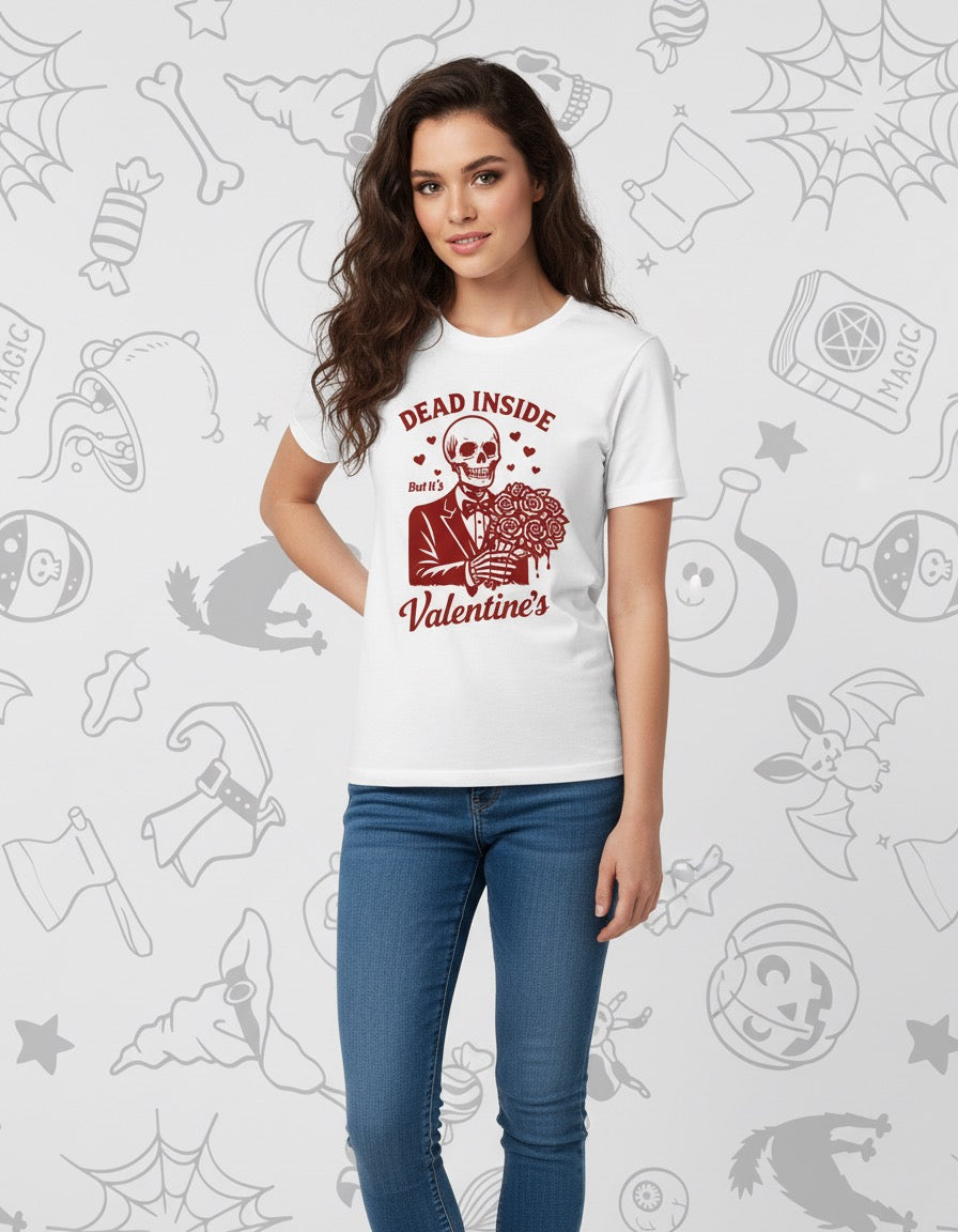 White t-shirt with red graphic of a skeleton holding a heart and text "Dead Inside Valentine's" worn with blue jeans.