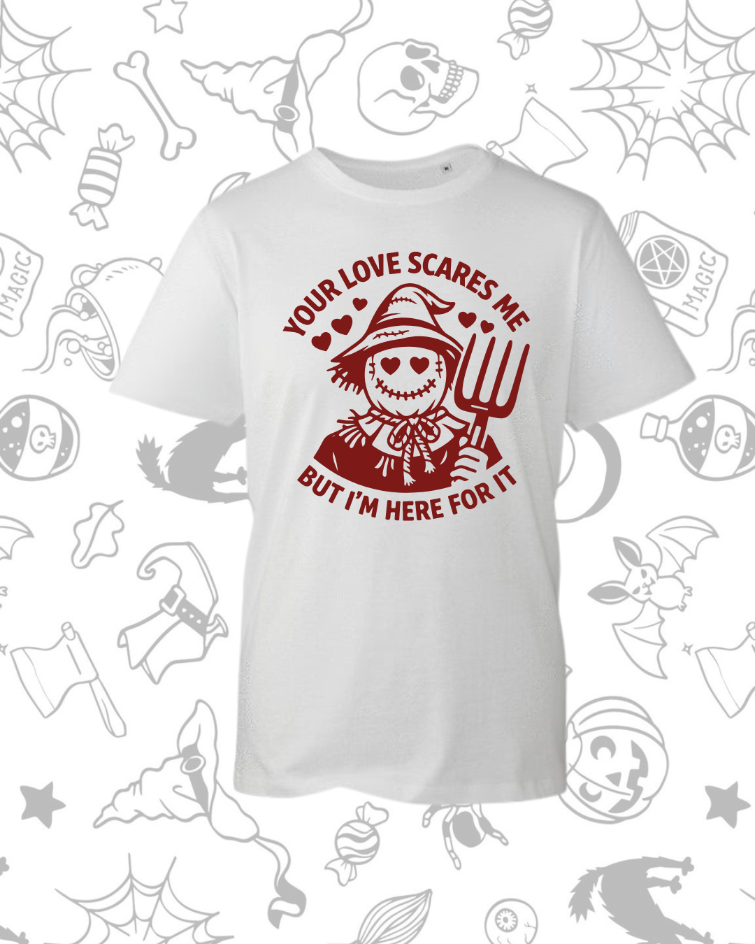 White t-shirt featuring a red graphic of a smiling scarecrow holding a pitchfork with the text "Your Love Scares Me But I'm.