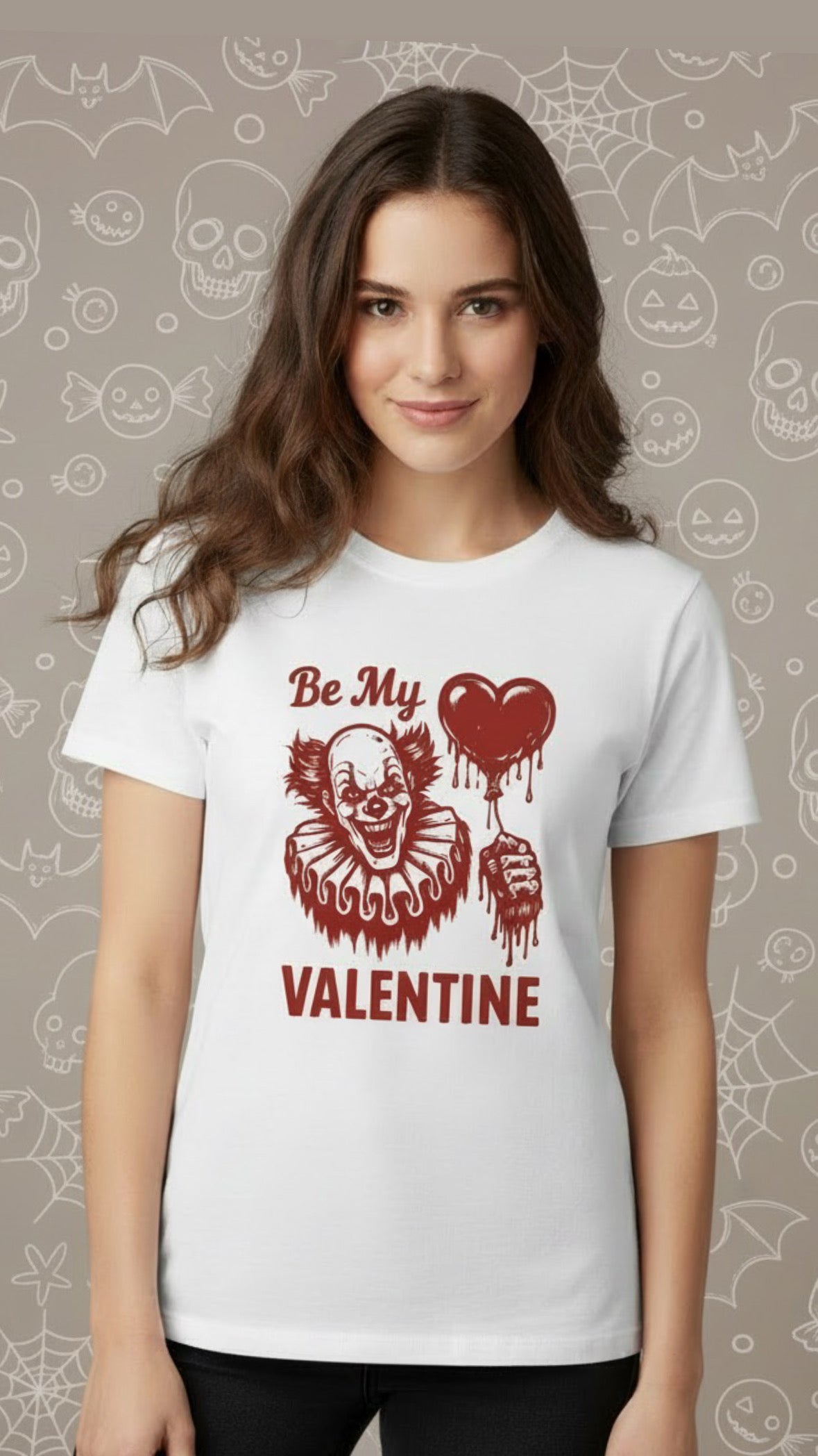 White t-shirt with red graphic of a grinning clown holding a heart-shaped balloon and text "Be My Valentine".