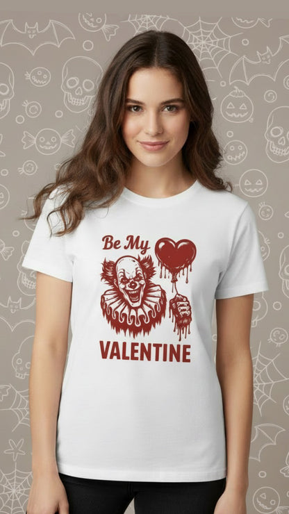 White t-shirt with red graphic of a grinning clown holding a heart-shaped balloon and text "Be My Valentine".