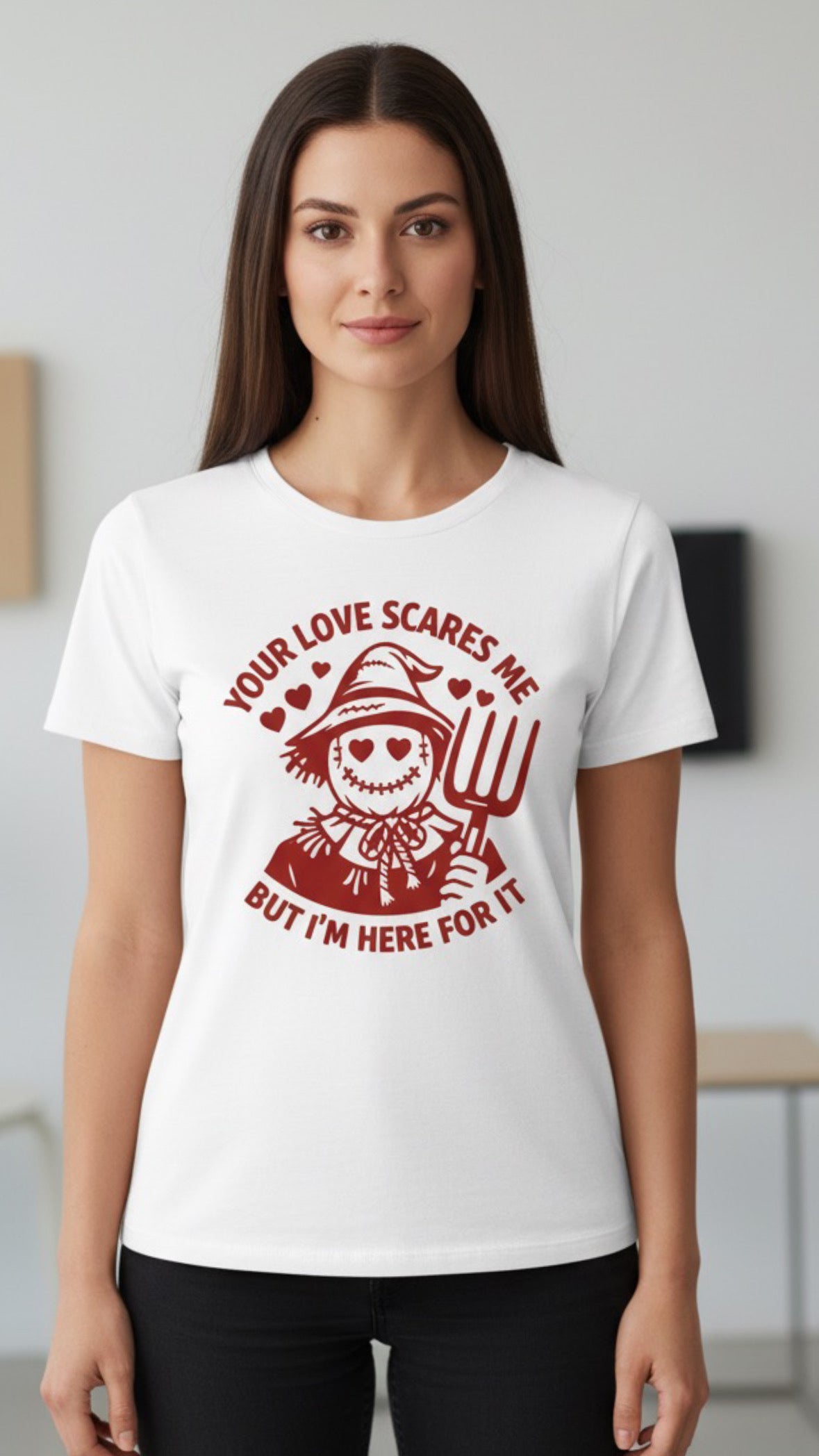 White t-shirt with maroon scarecrow graphic and text "Your Love Scares Me But I'm Here For It".