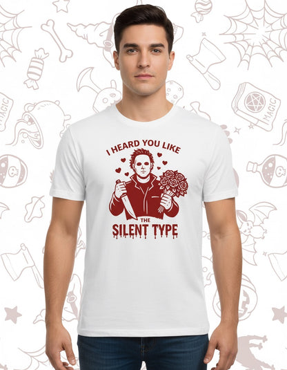 White cotton t-shirt featuring a maroon graphic of Michael Myers holding a knife and a pumpkin with the text "I heard you.